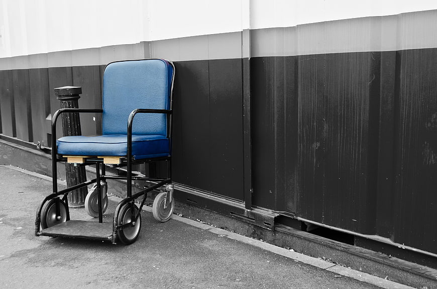 Blue wheelchair against black and white wall