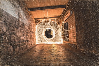 Steel wool sparks creating light painting circle in dark tunnel