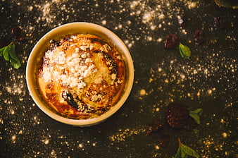 Overhead shot of baked dessert in ramekin with powdered sugar