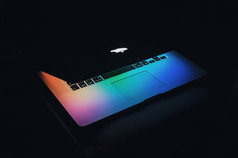 Illuminated MacBook with Rainbow Gradient in Dark Setting
