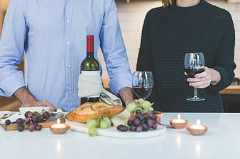 Couple Enjoying Wine and Cheese Platter with Candles