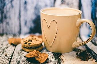 Creamy Coffee Mug with Heart and Cookies on Rustic Wood