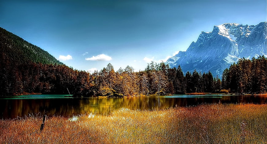 Autumn Lake Landscape with Snow-Capped Mountain and Golden Reeds