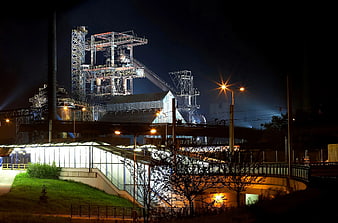 Industrial steelworks complex illuminated at night