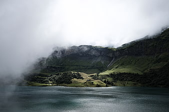 Misty Mountain Lake Landscape with Waterfall and Fog