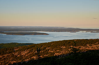 Scenic Coastal Landscape with Forested Hills and Ocean at Sunset