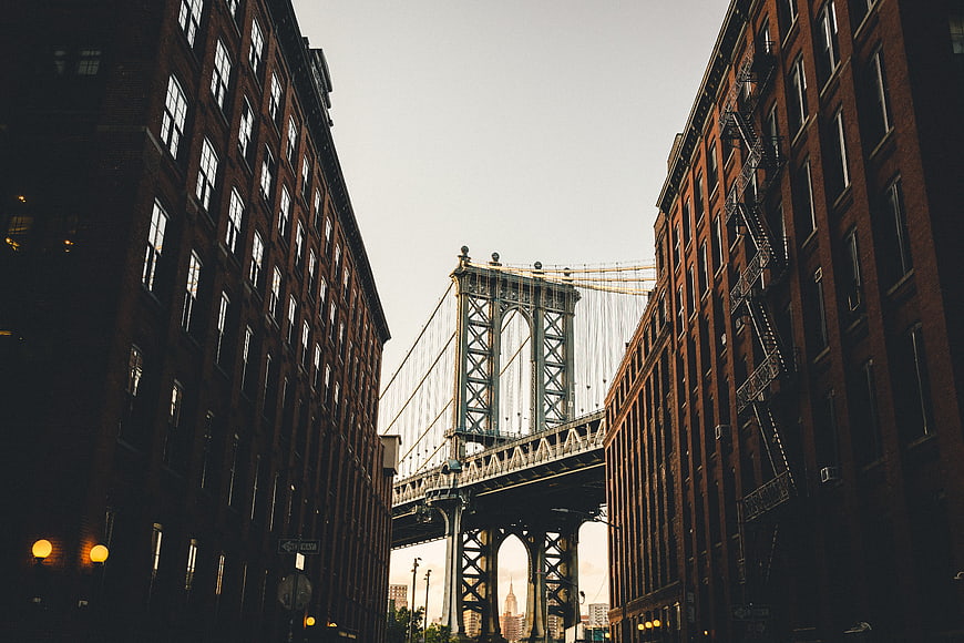 Manhattan Bridge View Between Brick Buildings