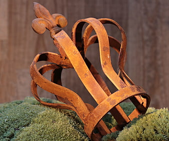 Rusty metal crown on moss background