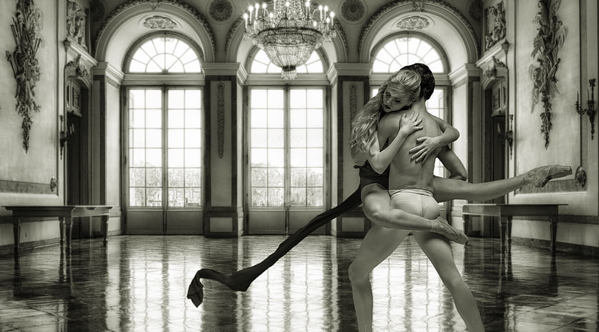 Ballet dancers performing a lift in a grand baroque ballroom