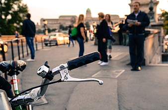Bicycle Handlebars on Parisian Bridge at Sunset