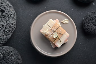 Handmade Natural Soap Bars on Ceramic Plate with Volcanic Rocks