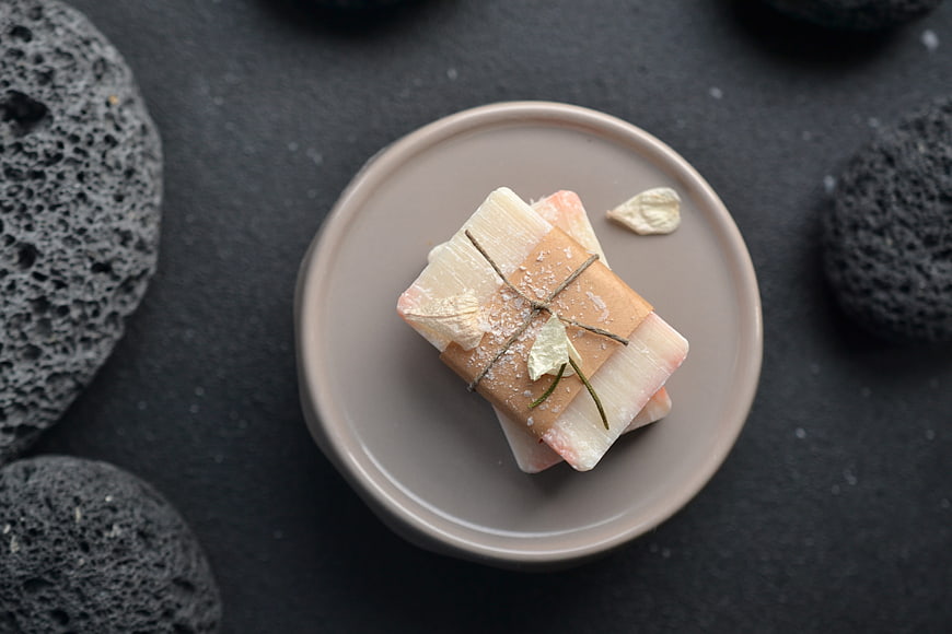 Handmade Natural Soap Bars on Ceramic Plate with Volcanic Rocks