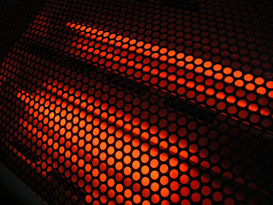 Abstract Glowing Red Perforated Metal Grid Pattern