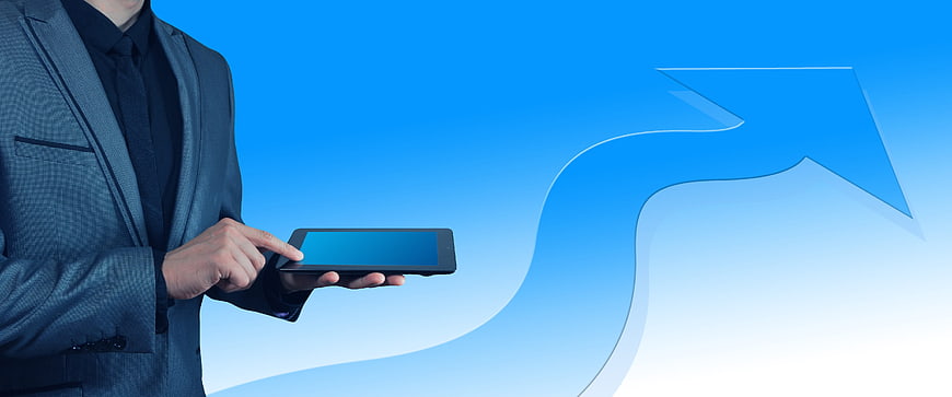 Businessman holding tablet with upward growth arrow on blue background