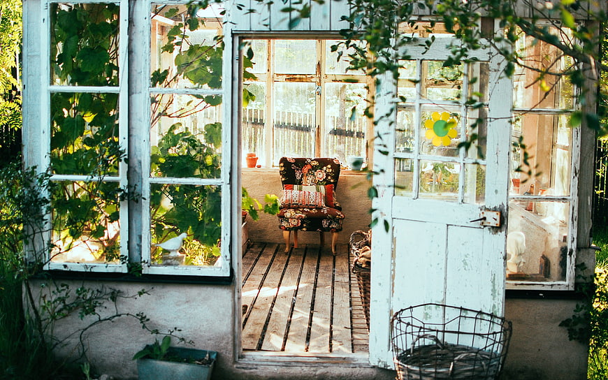 Rustic Garden Room with Vintage Floral Chair and Sunlight
