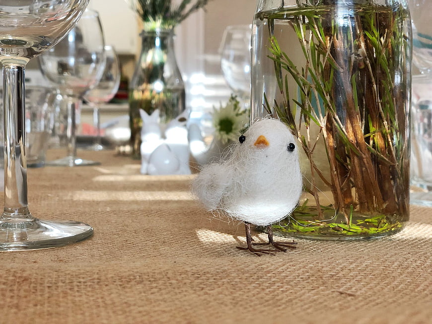 Cute handmade felt chick on rustic burlap table setting