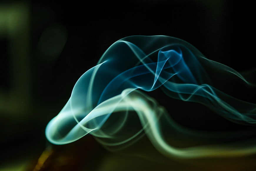 Abstract Blue and Green Smoke Swirls on Black Background