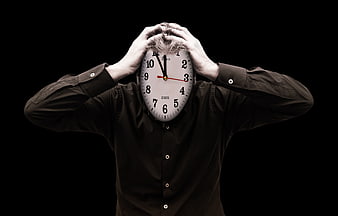 Man with clock face holding head in stress