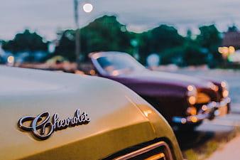 Close-up of a vintage Chevrolet emblem on a classic car hood