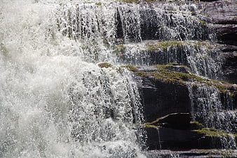 Powerful waterfall cascading over mossy rocks