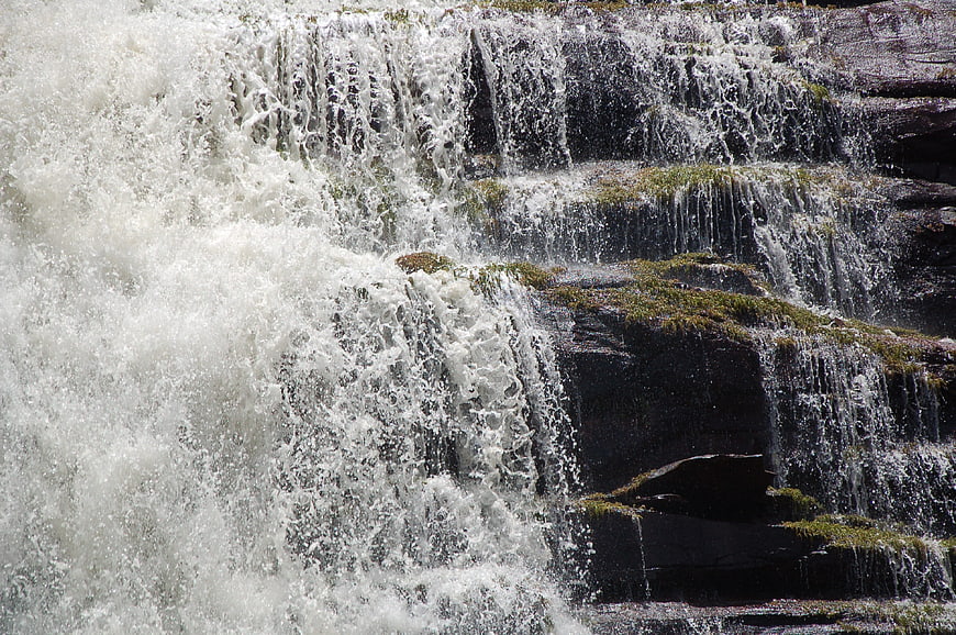 Powerful waterfall cascading over mossy rocks