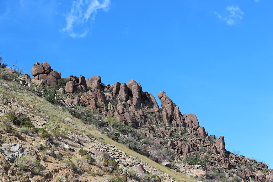 Rocky Desert Hillside with Blue Sky and Cacti