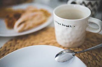 White Coffee Mug with Text on Woven Placemat