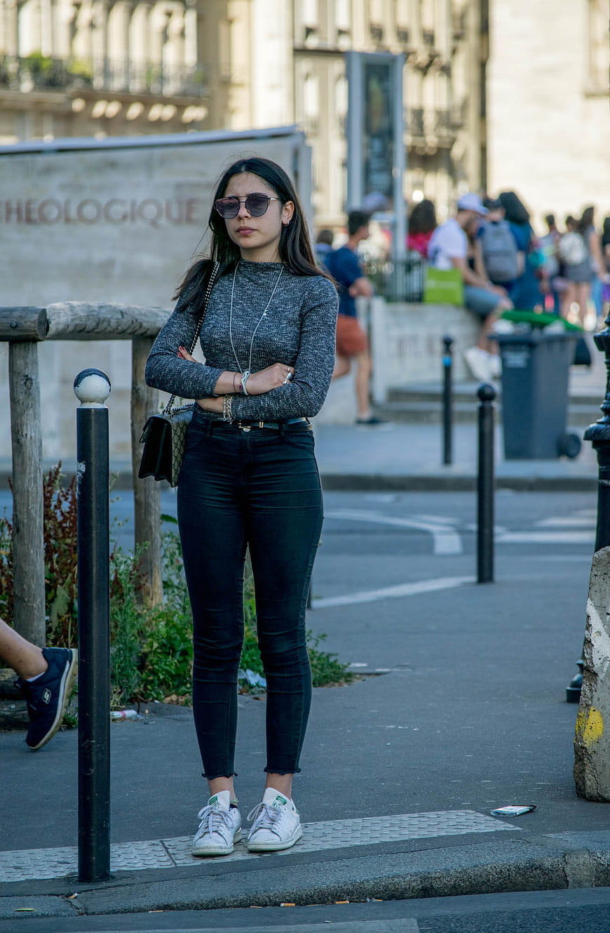 Stylish Woman in Black Jeans and Sunglasses on City Street