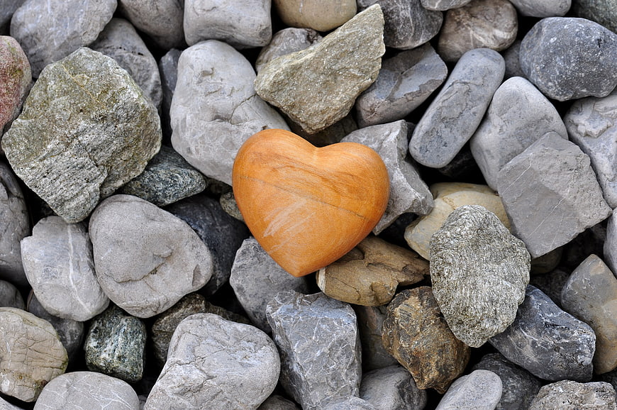 Wooden Heart On Gray River Stones