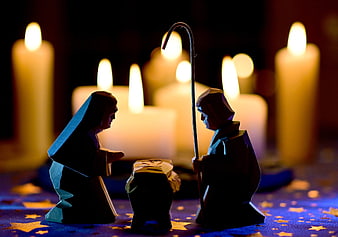 Silhouette of Holy Family Nativity Scene with Candles