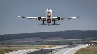 Airplane Taking Off From Runway With Landing Gear Down