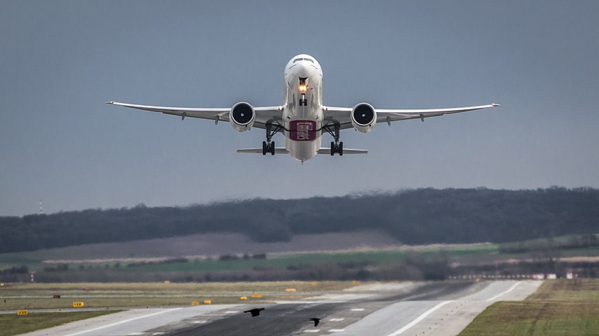 Airplane Taking Off From Runway With Landing Gear Down