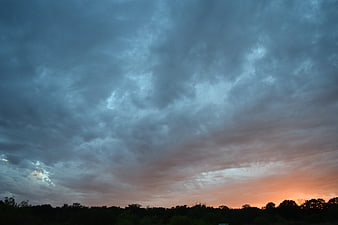 Dramatic Stormy Sunset Sky Over Silhouetted Forest