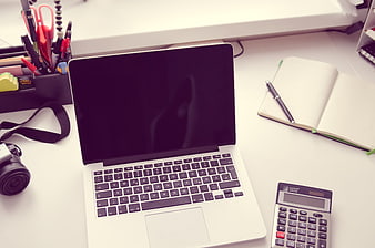 Apple Laptop, Calculator, and Notebook on White Office Desk