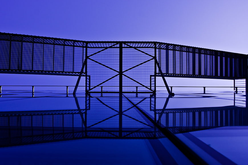 Abstract Blue Metal Fence Structure with Reflection