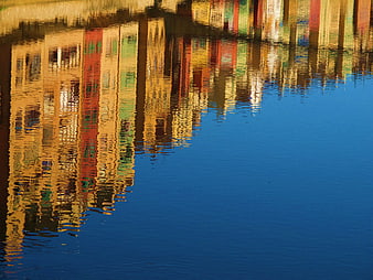 Colorful Building Reflections in Calm Blue Water