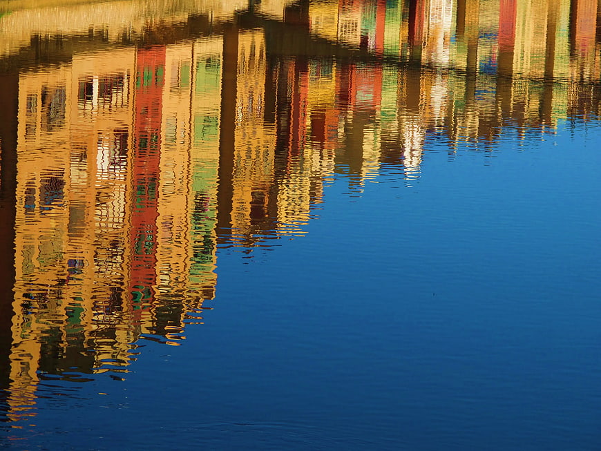 Colorful Building Reflections in Calm Blue Water