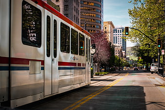 Silver UTA Trax light rail train on sunny city street