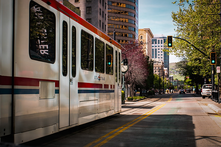 Silver UTA Trax light rail train on sunny city street