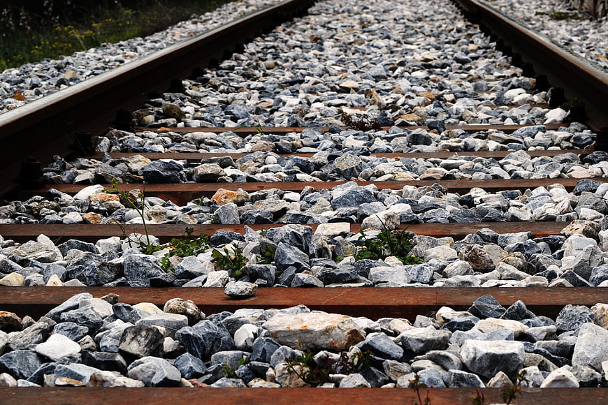 Close-up of railway tracks with gravel and wooden sleepers