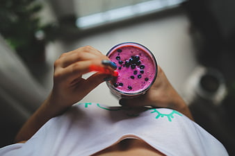 Top View of Woman Holding Berry Smoothie with Blueberries