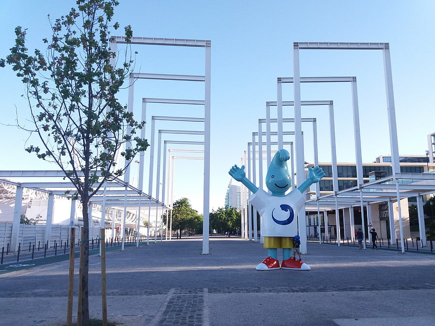 Blue mascot statue in Lisbon urban plaza with white frames
