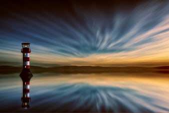 Dramatic Lighthouse with Streaked Sky and Reflection
