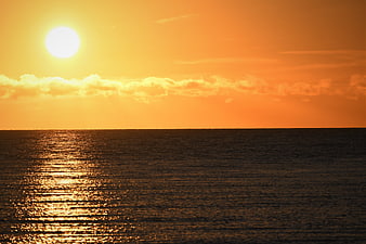 Golden Sunset Over Calm Ocean Horizon