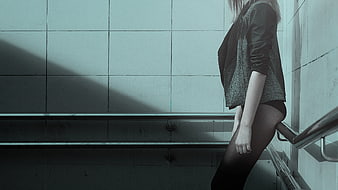 Woman in Black Jacket Leaning on Staircase Railing