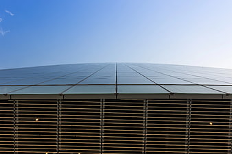 Modern Glass Building Roof Against Blue Sky