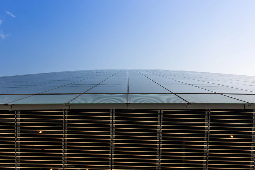 Modern Glass Building Roof Against Blue Sky