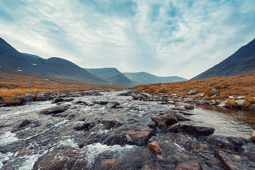 Scenic Mountain River Valley with Flowing Water and Autumn Foliage