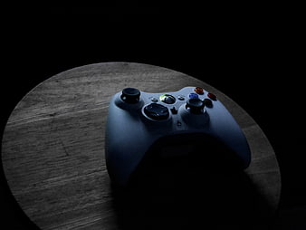 Dark moody Xbox controller on wooden surface