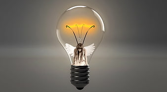 Sad fairy with wings resting inside a glowing lightbulb